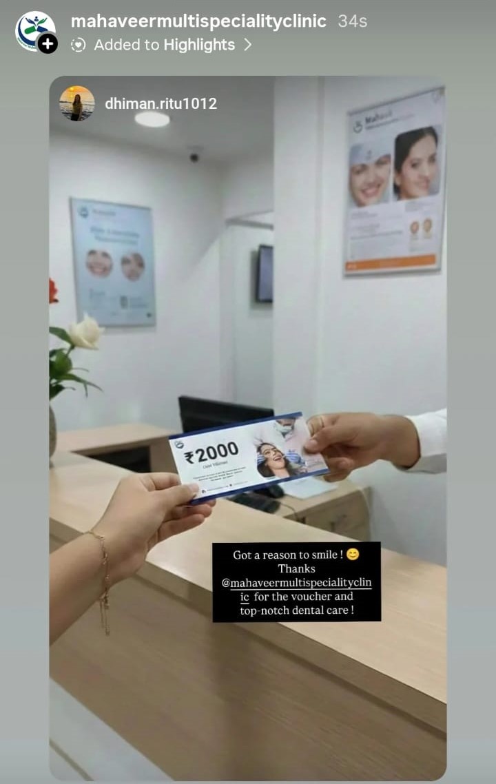 Patient receiving ₹2000 appreciation voucher at Mahaveer Multispeciality Clinic reception